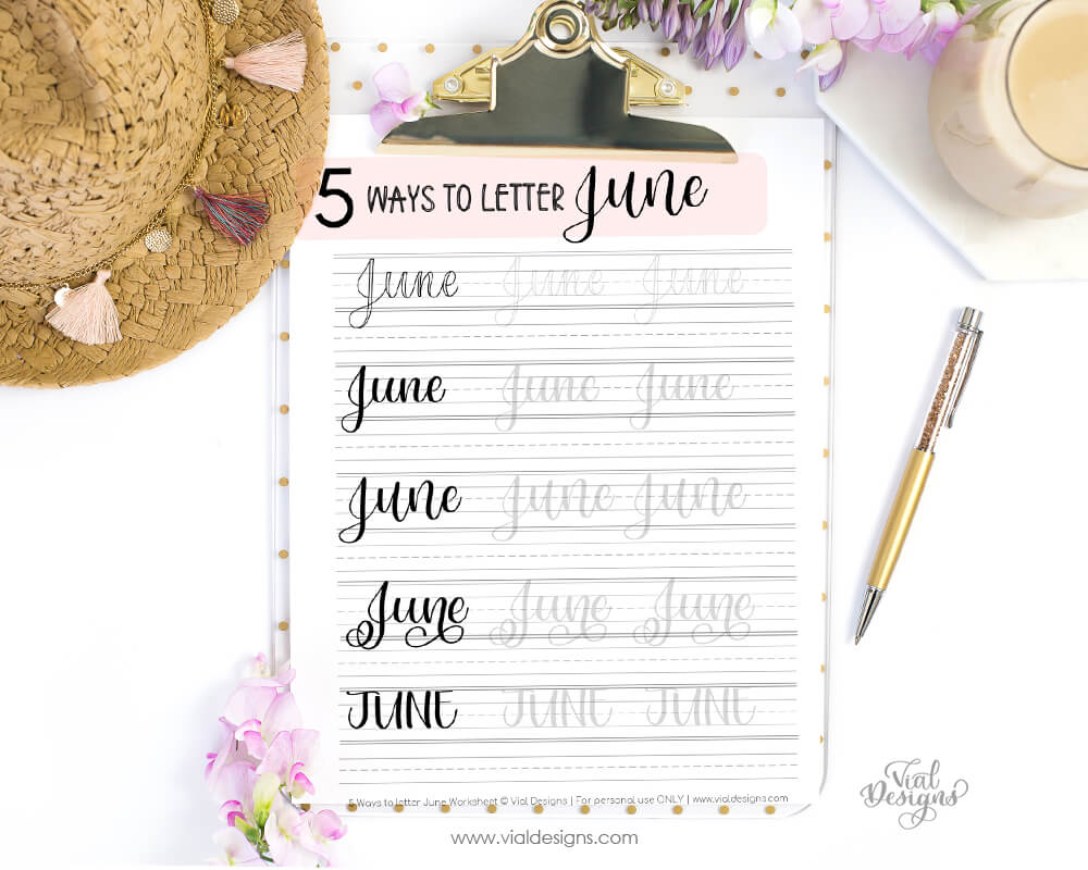 5 ways to letter June worksheet displayed on a clipboard with a pen and a hat next to it