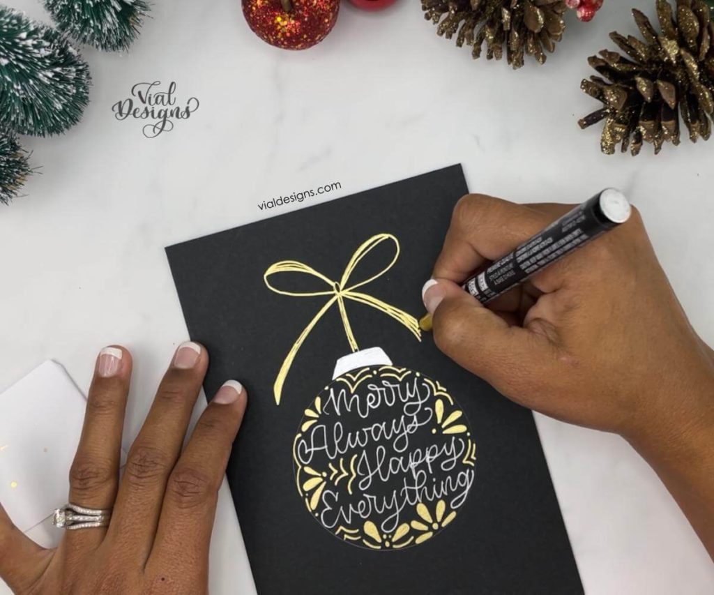 drawing-a-bow-in-the-hand-lettered-ornament-card