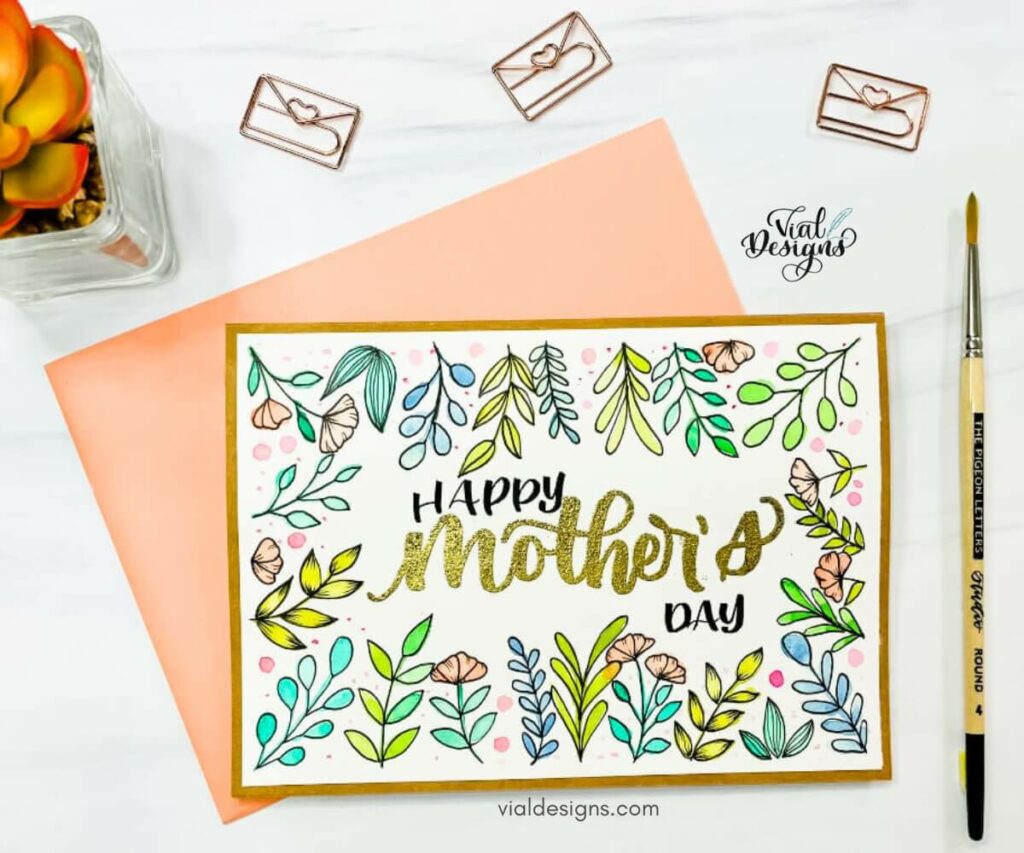 Happy mother's day card with embossed lettering and watercolor floral doodles.